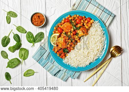 Chicken And Chickpea Curry Served With Jasmine Rice With Cherry Tomatoes, Baby Spinach, Yellow Curry