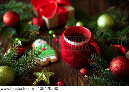 Hot Christmas Tea With Gingerbread Cookie On Wooden Table. Top View. New Year And Christmas Celebrat
