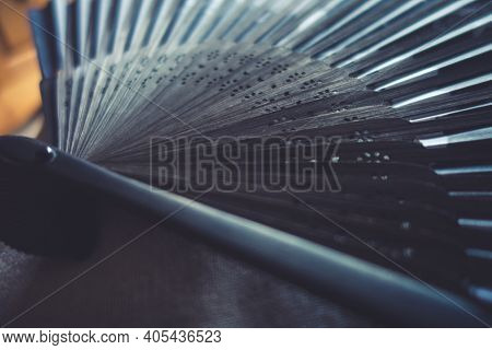 Traditional Black Hand Fand Closeup View. Abstract Background