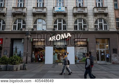 Belgrade, Serbia - May 12, 2020: People Passing By The Entrance Of An Aroma Market Supermarket With 