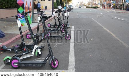 San Diego, California Usa - 4 Jan 2020: Row Of Ride Sharing Electric Scooters Parked On Street In Ga