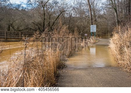 The Creek Overflowing Flooding The Area Onto The Trails At George Pierce Park And Reaching The Bridg