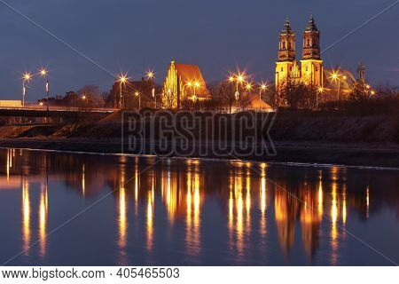 Poznan Cathedral, Archcathedral Basilica Of St Peter And St Paul At Night With Reflection In Warta R