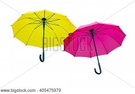 Two yellow and red color umbrellas on white background.