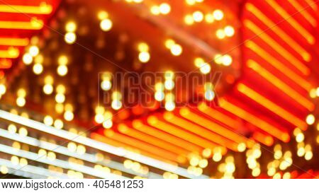 Defocused Old Fasioned Electric Lamps Glowing At Night. Abstract Close Up Of Blurred Retro Casino De