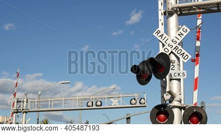 Level Crossing Warning Signal In Usa. Crossbuck Notice And Red Traffic Light On Rail Road Intersecti