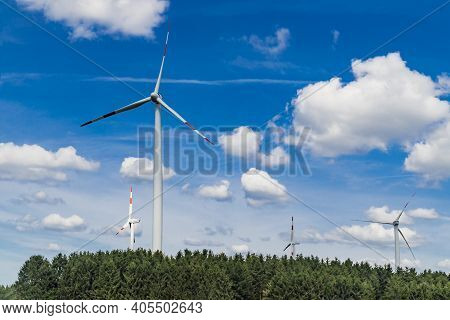 Windmill Park Sourround Blue Clouds In Summertime In Germany
