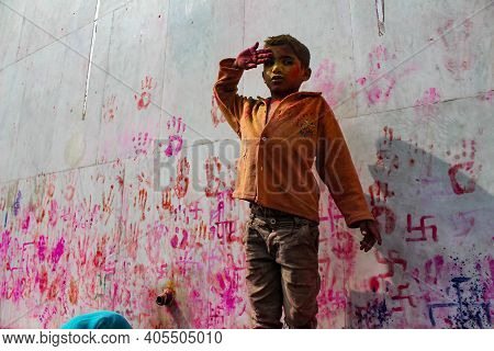 Mathura, Uttar Pradesh, India- January 28 2020: Potrait Of A Young Kid Covered Fully In Colors Of Ho