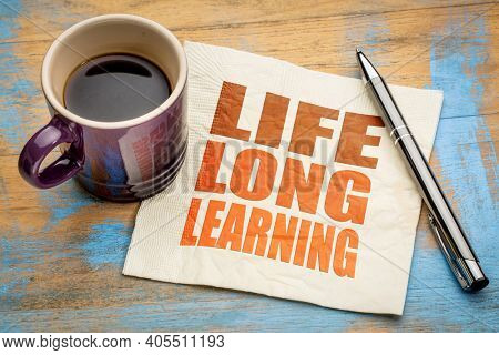 lifelong learning concept -  word abstract on a napkin with a cup of espresso coffee, education, lifestyle and personal development