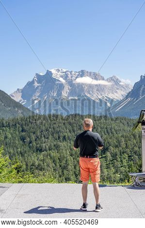 Fernpass, Austria - Aug 6, 2020: Tourist Take Photo Of West Side Of Zugspitze In Snow In Fernpass Au