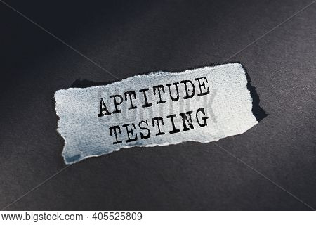 Aptitude Testing - Text On Torn Paper On Dark Desk In Sunlight.
