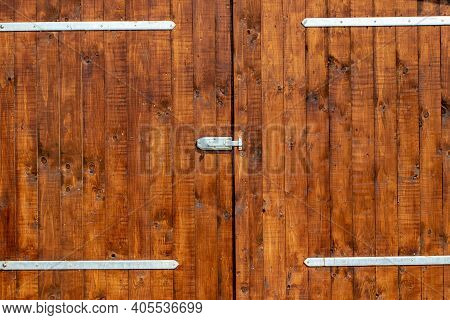 Closeup Of A Wooden Door With Modern Hinges Outsite.