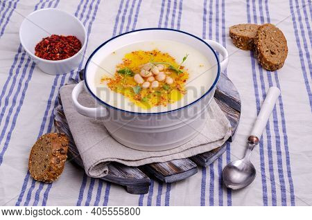 Vegetable Cream Soup With Beans And Spicy Oil In A Bowl On A Textile Background. Selective Focus.