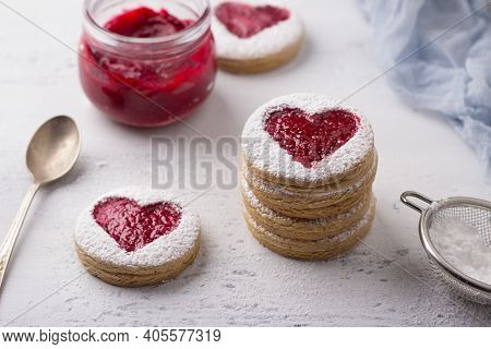 Homemade Shortbread Spicy Cookie With Red Hearts With Jam On White Plate And A Cup Of Coffee  On Gra