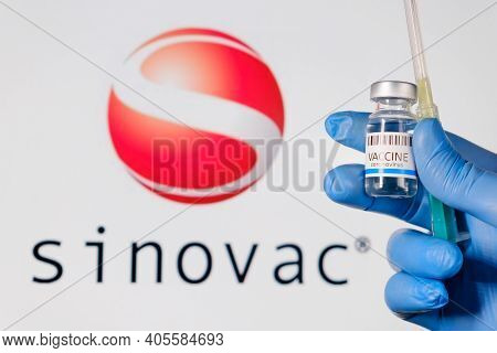 Sinovac Ampule With Vaccine For Prevention Of Coronavirus, Sars-cov-2 And Syringe In Doctors Hand In