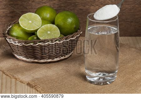 Water, Baking Soda And Lemon; Photo On Wooden Background.