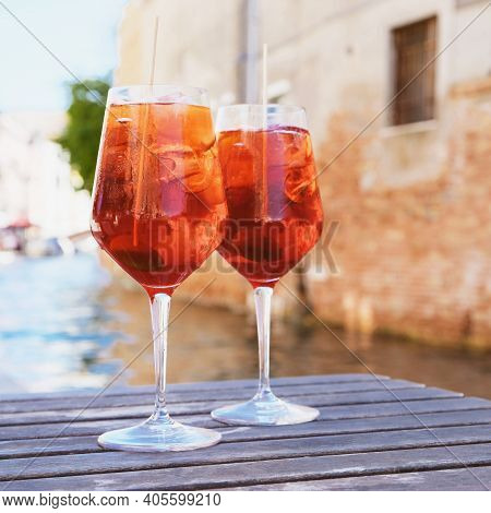 Two Glasses Of Spritz Veneziano Cocktail Served Near The Venetian Canal.  Popular Italian Summer Ape