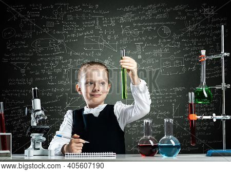 Little Girl Scientist Examining Test Tube With Chemical Reagent. Research And Education In School. C