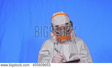 Scientist Virologist In Respirator Makes Write In An Tablet Computer With Stylus. Woman Wearing Prot