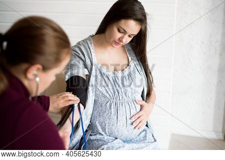 Measuring The Pressure Of A Pregnant Woman At Home. Poor Well-being Of A Pregnant Woman.