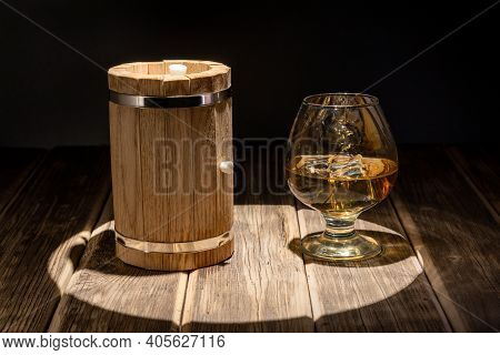 Mini Oak Barrel For Making Homemade Whiskey, And A Glass With Ice. Spotlight