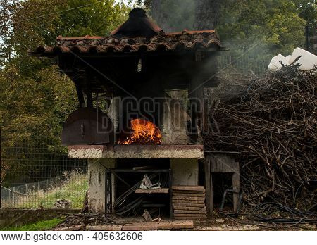 External Wood Oven. Traditional Pizza Oven Burning Wood.flame In The Furnace.