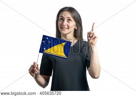 Happy Young White Woman Holding Flag Of Tokelau And Points Thumbs Up Isolated On A White Background.