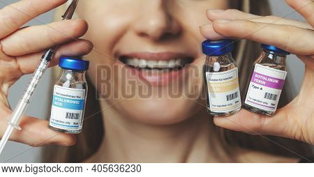 Smiling Woman With Cosmetic Injection Vials And Syringe In Hands. Anti-aging Non Surgical Treatments
