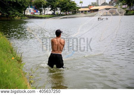 Fisherman On Lake Fishing