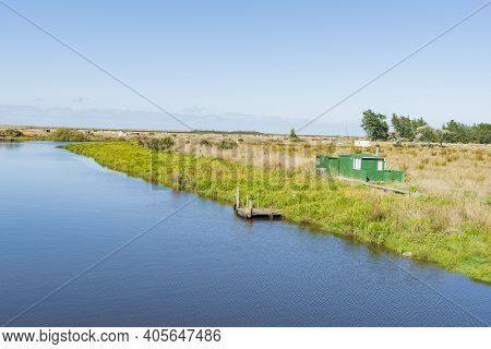 Scenic Titiroa Stream In Southland Leading To Coast With  Traditional Whitebaiter Shacks On Edge In 