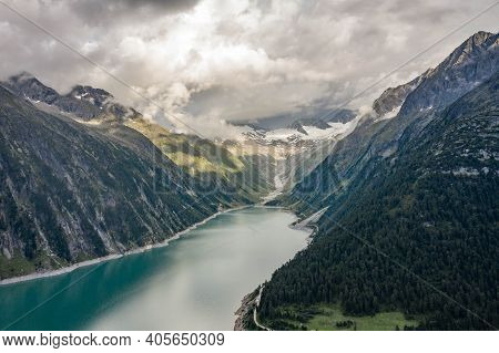Aerial Drone Shot Of Schlegeisspeicher Resevoir With Galcier View At Dusk