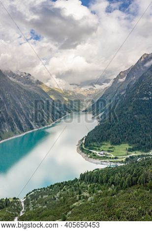 Aerial Drone Shot Of Schlegeisspeicher Resevoir With Galcier View At Dusk