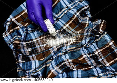 Concept Poisoning Of An Oppositionist A Hand In A Blue Protective Glove Pours White Powder On The Fl