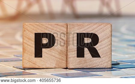 Pr Word On Wood Blocks On Relaxed Beach Background. Luxury Life Concept. Public Relation Marketing B