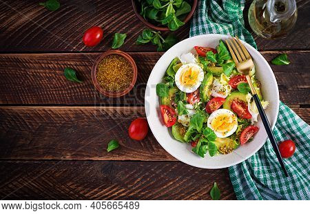 Fresh Avocado Salad With Tomato, Avocado, Boiled Eggs And Fresh Lettuce. Ketogenic Diet Breakfast.  