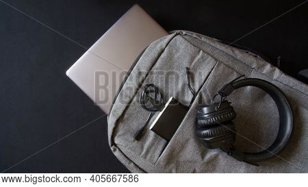 Small Gray Textile City Backpack With Laptop Or Ultrabook, Power Bank And Wireless Headphones. Trave