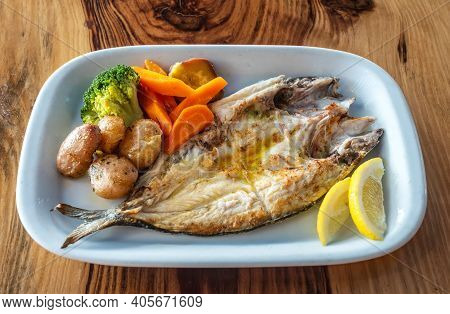 Grilled Fish Plate With Some Nicely Roasted Potatoes, Carrots And Broccoli On The Side.