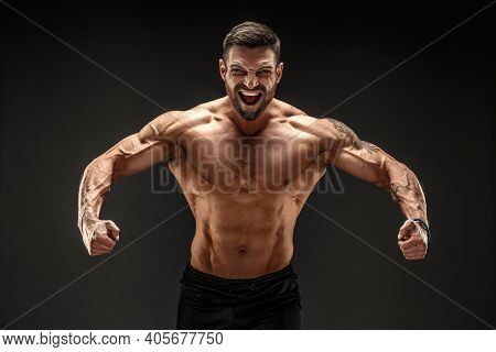 Very Brawny Guy Bodybuilder Posing. Beautiful Sporty Guy Male Power. Fitness Muscled Man. Roar