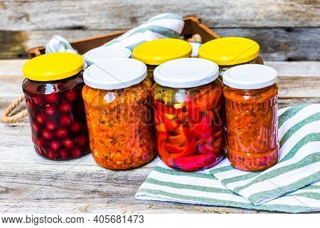 Jars With Variety Of Canned Vegetables And Fruits, Jars With Zacusca. Preserved Food Concept In A Ru