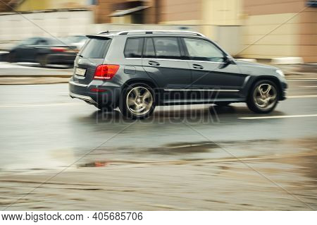 Moscow, Russia - January 29, 2021: Fast Moving Suv Rides On A Winter City Road. A Car On Wet Slipper