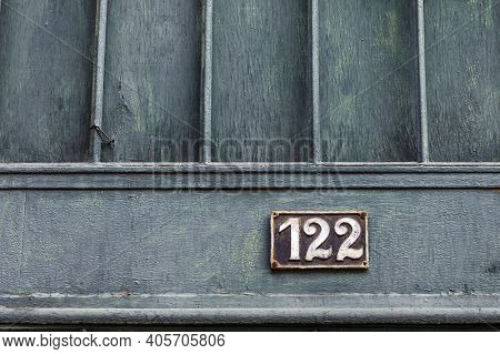 Number 122, The Number Of Houses, Apartments, Streets. The White Number On A Brown Metal Plate, Hous
