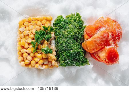 Colorful Frozen Briquettes Of Berries, Greens And Veggies On Ice. Top View.