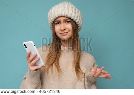 Closeup Portrait Photo Of Beautiful Dissatisfied Young Blonde Woman Wearing Stylish Beige Warm Sweat