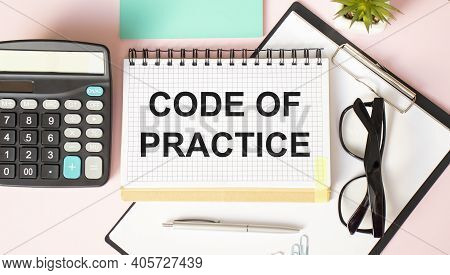 Code Of Practice Text Written On A Notebook With Pencils And Calculater.