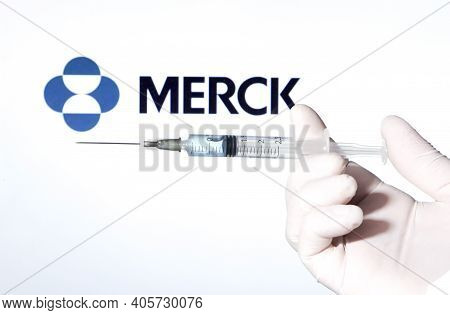 Madrid, Spain- January 7, 2020: Hand On White Surgery Glove Holding Syringe With Covid Vaccine. In T