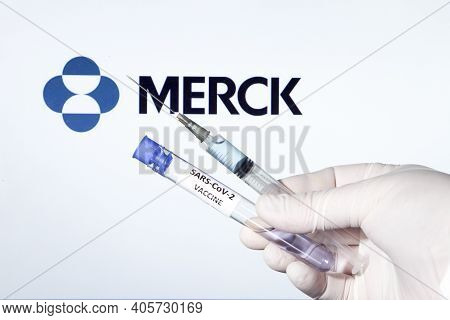 Madrid, Spain- January 7, 2020: Hand On White Surgery Glove Holding Syringe With Covid Vaccine. In T