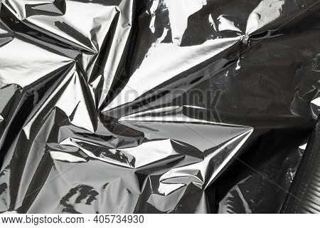 Plastic Texture Background. Wrap Transparent Dark Cellophane. Cellophane Black Shiny Film Bag Patter