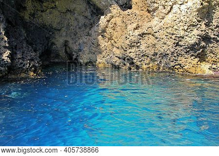 Blue Sea Water, Rocks, A Cave Carved In The Rock, A Cave In The Rocks By The Sea, A Blue Cave In Sic