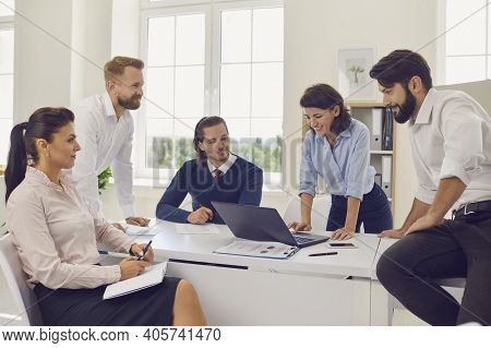 Group Of Young Positive Business People Partners Sitting In Office And Having Brainstorm About Start