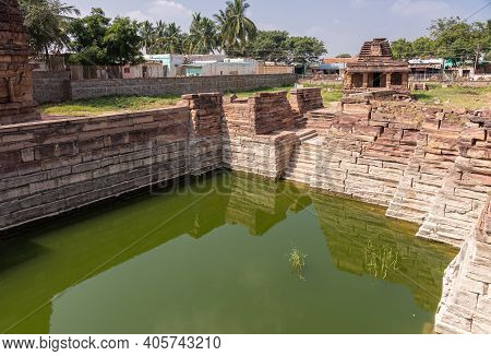 Aihole, Karnataka, India - November 7, 2013: Badigera Gudi Temple In Brown Stone Behind The Steps In